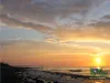 Computer screen wallpaper: Sun setting over the ocean