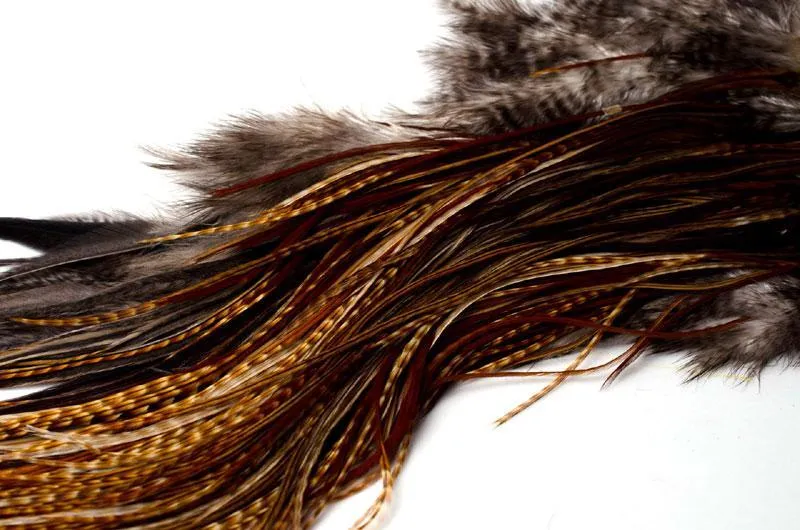 Messy and patchy - It might look like a mess, but this oddly colored Whiting saddle was selected for its extremely fine hackle, suitable for the smallest of flies down to hook sizes in the 20\'s, 22\'s and 24\'s. I rarely tie in these sizes, and having a selection of badger, cree and uniformly colored feathers on one skin is actually perfect for me.
