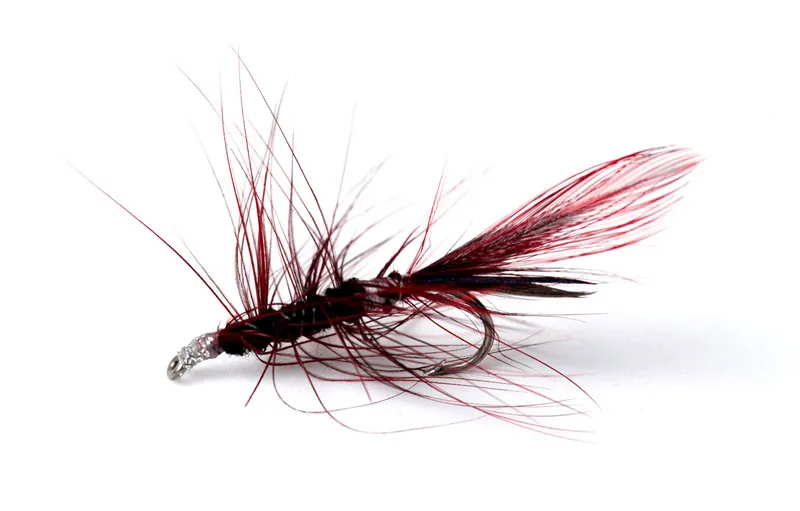 Yuck! - This is most likely one of the very first flies I ever tied. I have really tried to groom it, but honestly: the hackle is a mess and all too long, there\'s tying thread on the outside of the body and the head is varnished with silver flake nail varnish. Yuck!